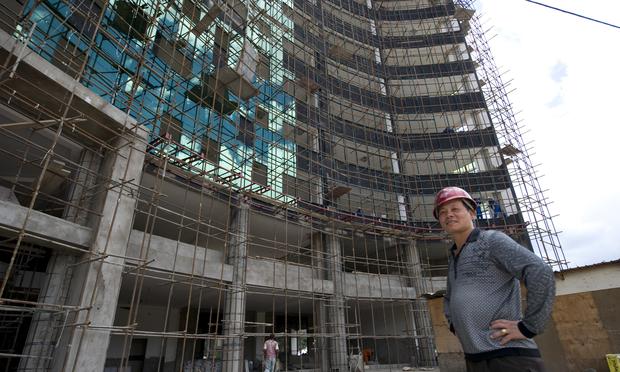 Chinese constructor Liou stands next to a site in Nairobi on May 13, 2014. Kenyan contractors are losing out to Chinese firms that are grabbing lucrative construction tenders for private projects. Chinese constructor Liou stands next to a site in Nairobi on May 13, 2014. Kenyan contractors are losing out to Chinese firms that are grabbing lucrative construction tenders for private projects.
