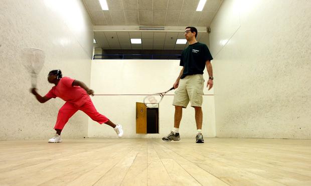 Squash instructor and StreetSquash founder George Polsky plays squash with a student during a summer StreetSquash education session July 9, 2003