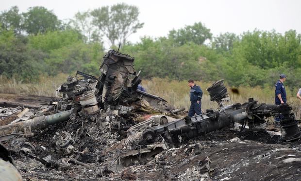 Rescuers stand on July 18, 2014 on the site of the crash of a Malaysian airliner carrying 298 people from Amsterdam to Kuala Lumpur, near the town of Shaktarsk, in rebel-held east Ukraine.