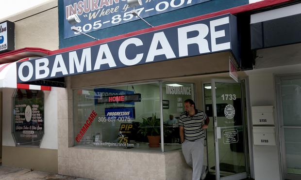 Baseel Farah walks out of Leading Insurance Agency as the insurance agency helps enroll people in health insurance plans under the Affordable Care Act on February 13, 2014 in Miami, Florida.