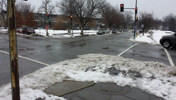 At this D.C. 'sneckdown,' the snow shows parts of the roadway that could be replaced with a wider sidewalk, bike lane or plaza.