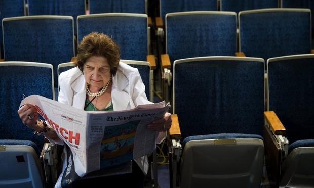 (FILE PHOTO) Senior White House Correspondent Helen Thomas reads the newspaper while sitting in her chair in the White House press room August 2, 2006 in Washington, DC.