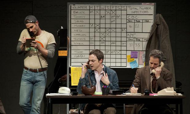 Luke Macfarlane, Jim Parsons, and Patrick Breen (left-to-right) work the switchboard for an activist group fighting the epidemic in The Normal Heart. Luke Macfarlane, Jim Parsons, and Patrick Breen (left-to-right) work the switchboard for an activist group fighting the epidemic in The Normal Heart.