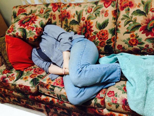 man snoozing on couch