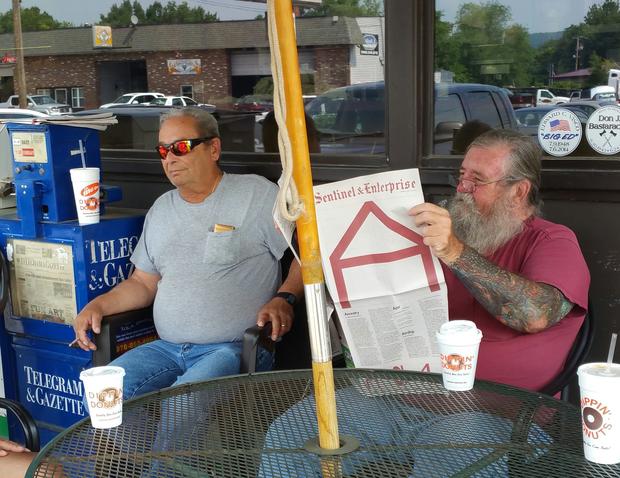 Fitchburg residents reading the Sentinel   Enterprise, featuring the art of Anna Schuleit Harbert
