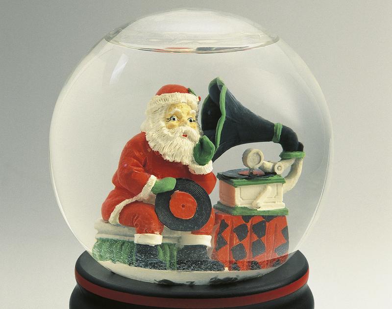 Close-up of a figurine of a Santa Claus listening to a gramophone in a snow globe