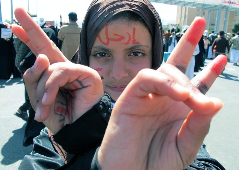 A young Yemeni with the word 'leave' written in Arabic on her forehead shows the V-sign for victory during a protest against the regime of Ali Abdullah Saleh in the capital Sanaa, on Nov. 11, 2011.