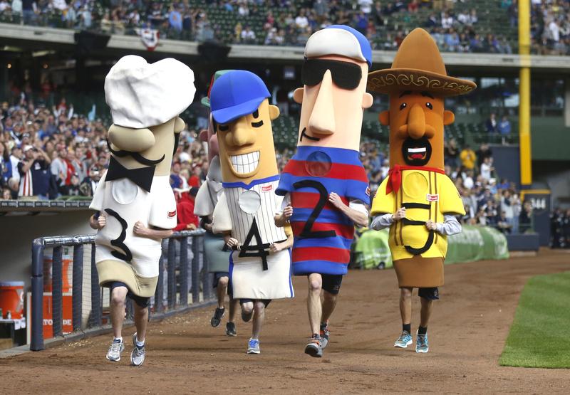 The racing sausages run around the field during the St. Louis Cardinals and Milwaukee Brewers game at Miller Park on April 8, 2012 in Milwaukee, Wisconsin.