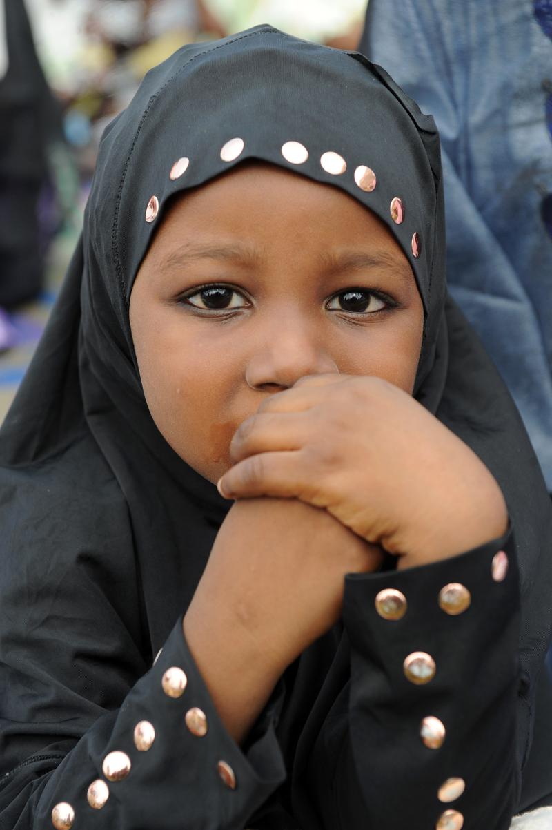 A young girl prays on the first day of Eid al-Fitr at Obalende praying ground in Lagos, Nigeria on August 19, 2012.