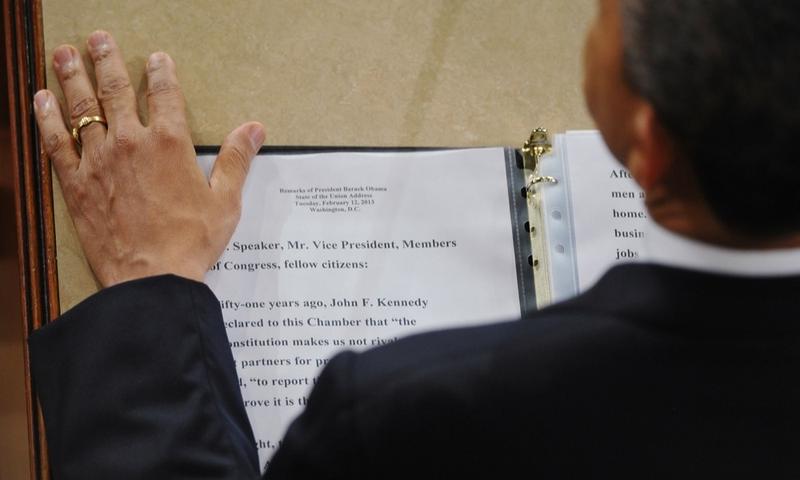 President Barack Obama rests his hand next to a copy of his speech as he delivers his State of the Union address.
