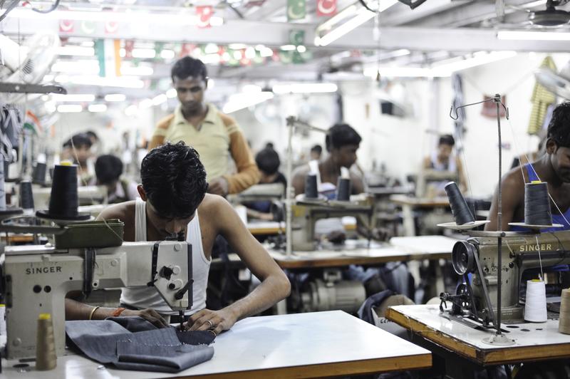Inside a sweatshop in Dharavi Slum in Mumbai workers produce jeans for the western market.