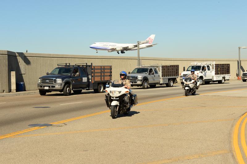 Police ride motorcyles outside Los Angeles International Airport after a shooting inside Terminal 3.