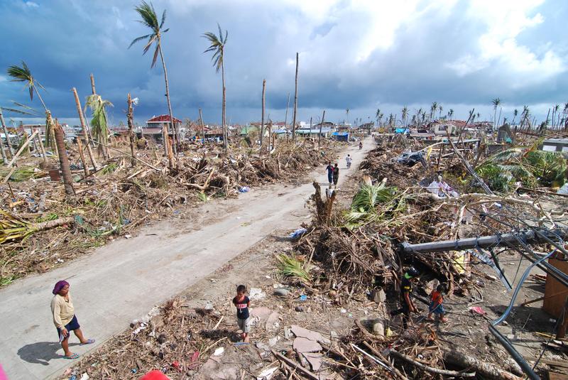 Affected residents survey the damage in Tacloban City on November 14, 2013 in Tacloban, Philippines.