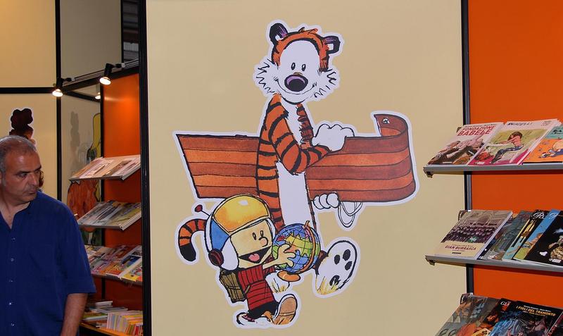 A painting on the wall of a comic book shop of "Calvin and Hobbes."