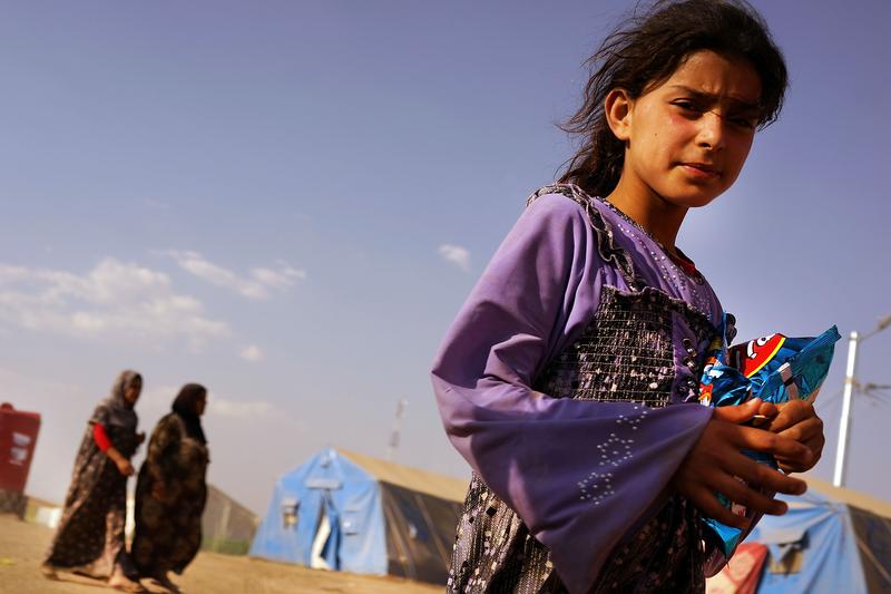 An Iraqi girl stands inside of a displacement camp for those caught-up in the fighting in and around the city of Mosul on June 28, 2014 in Khazair, Iraq. Tens of thousands have fled ISIS.