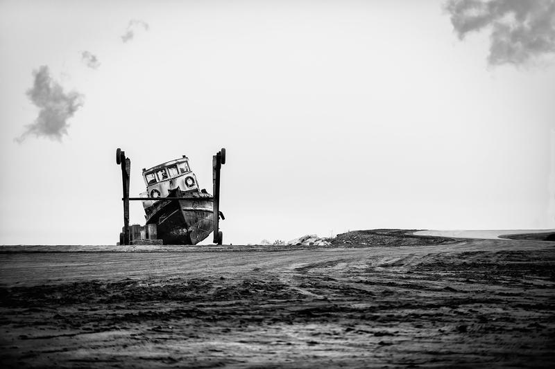 Frozen in and leaking oil, this tug boat was pulled from the small boat harbor in Nome, Alaska and now sits abandoned.