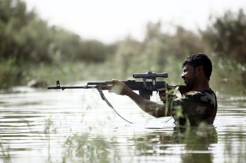A fighter loyal to Iraqi Shiite cleric Moqtada al-Sadr takes part in a last combat training near the city of Najaf on August 23, 2014, before joining the government forces to fight ISIS.