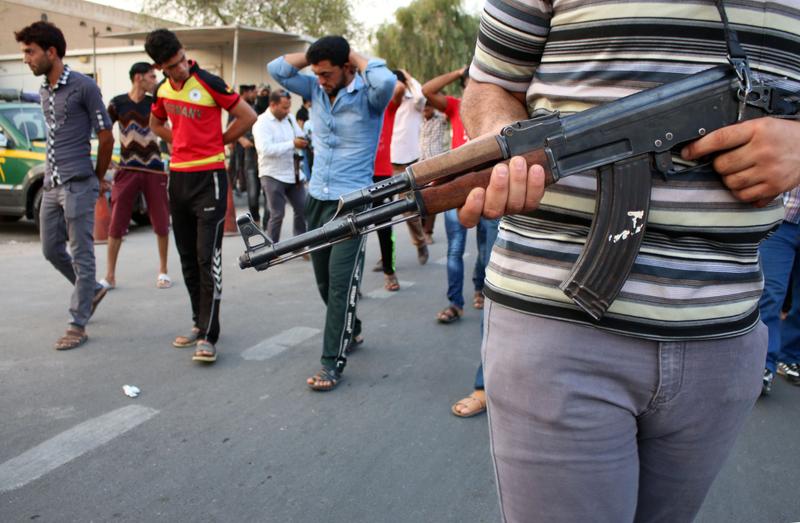 Supporters of the al-Fadila party perform the simulation of an execution during a protest to ask for justice for members of the Iraqi forces who were executed by ISIS. Sept. 3, 2014