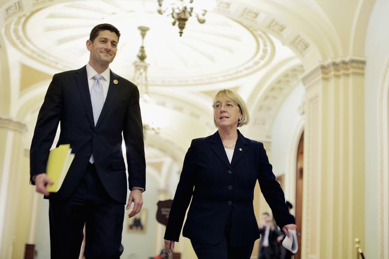 Rep. Paul Ryan (R-WI) and Sen. Patty Murray (D-WA) walk past the Senate chamber on their way to a press conference to announce a bipartisan budget deal. Dec. 10, 2013
