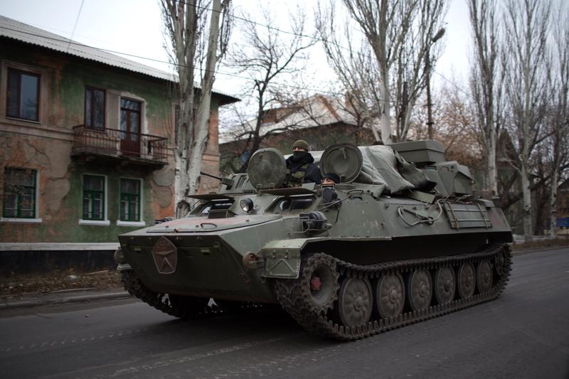 An amored personnel carrier (APC) rolls on November 12, 2014 on a main road in rebel-territory near the village of Torez, east of Donetsk, in eastern Ukraine.