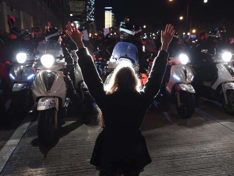 A protestor hold up her hands in front of the NYPD as she and others block traffic on the West Side Highway to protest the non-indictment in the case of Eric Garner. December 4, 2014 in New York City.