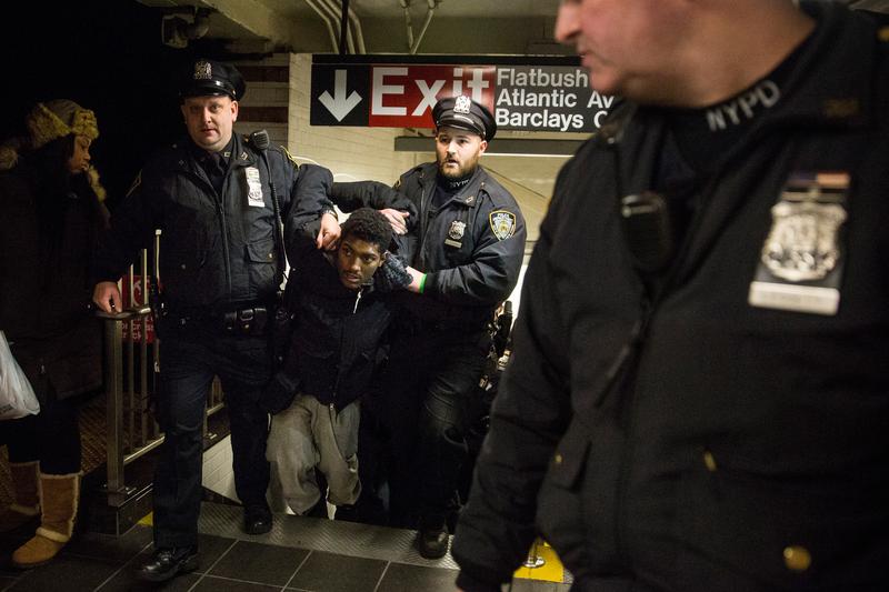 Police arrest a demonstrator protesting the grand jury's decision not to indict a police officer involved in the chokehold death of Eric Garner inside the Barclays Center subway station. Dec. 8, 2014