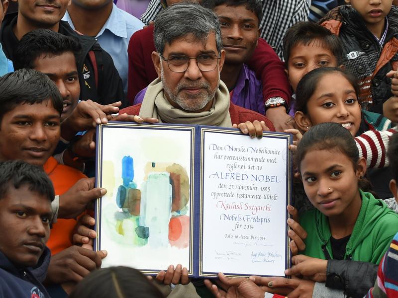 Nobel Peace Prize winner Kailash Satyarthi poses with children after paying tribute at Raj Ghat, the memorial for India's founding father Mahatma Gandhi, in New Delhi. December 14, 2014