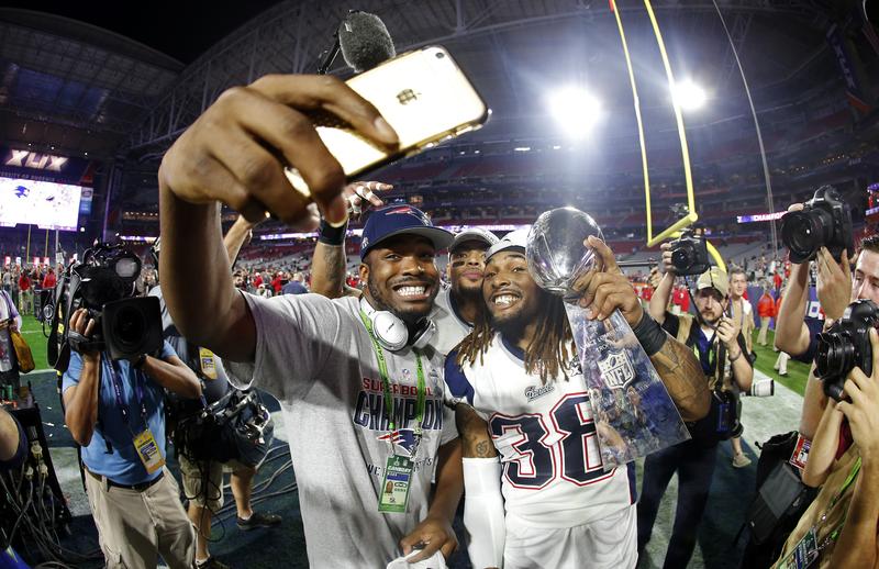 Members of the New England Patriots celebrate with the Vince Lombardi Trophy after defeating the Seattle Seahawks 28-24 in Super Bowl XLIX.
