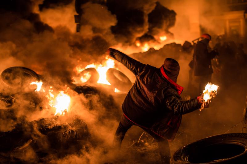 An anti-government protester throws a Molotov cocktail during clashes with police on Hrushevskoho Street near Dynamo stadium on January 25, 2014 in Kiev, Ukraine.