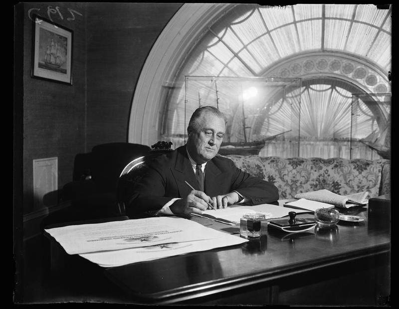 FDR signs a bill in Washington, D.C. in the East Hall of the White House