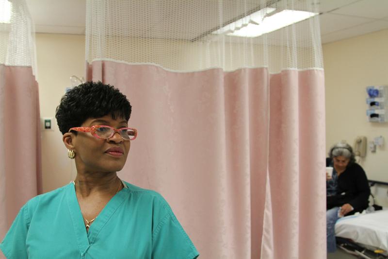 Certified Nurse Assistant Cynthia Johnson checks on a patient. Still from the documentary "The Waiting Room."