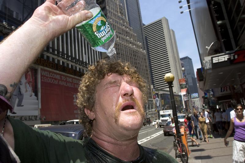 Wayne Semancik of Trenton, New Jersey pours water on his head to cool himself off July 18, 2006 in New York City.