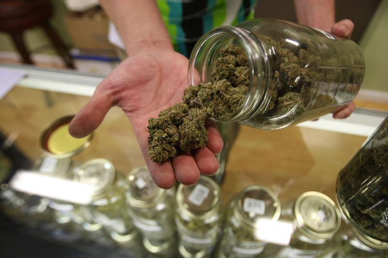 Dave Warden, a bud tender at Private Organic Therapy (P.O.T.), a non-profit co-operative medical marijuana dispensary, displays various types of marijuana available to patients on October 19, 2009.