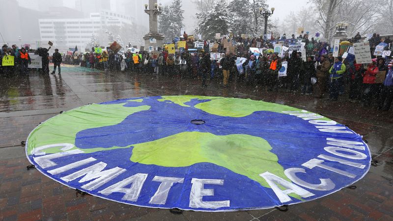 Participants chant during a climate change awareness rally, in Denver, Saturday, April 29, 2017.