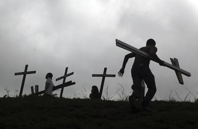 5/15/17: People place crosses, representing those who have died during the most recent opposition protests, on the side of the highway during a national sit-in against President Nicolas Maduro.