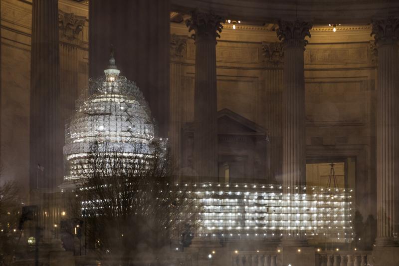 The Capitol in Washington is illuminated during a thunderstorm with the rotunda of the Russell Senate Office Building reflected on the rain-covered windows, late Wednesday afternoon, Feb. 24, 2016.