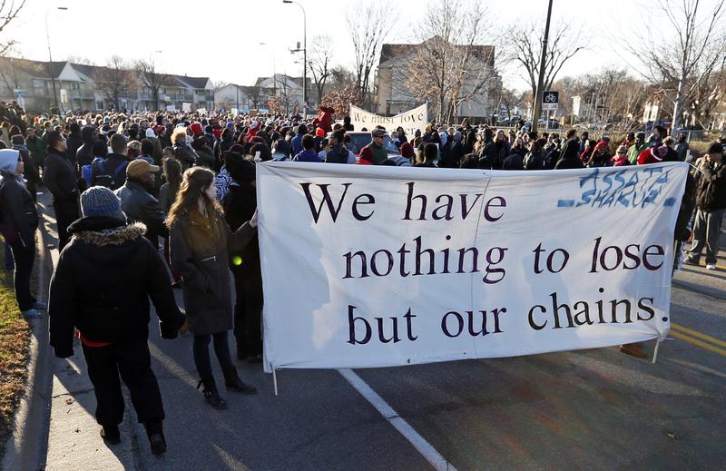 Black Lives Matter protesters and supporters march from the Minneapolis Police Department's Fourth Precinct to the Federal Building in Minneapolis, Tuesday, Nov. 24, 2015.