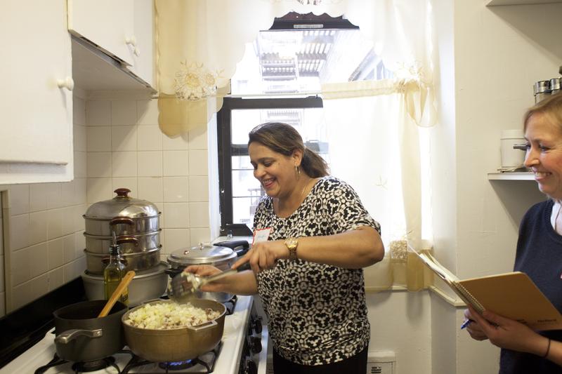 Nawida Saidhosin teaching an Afghani cooking workshop in her kitchen.