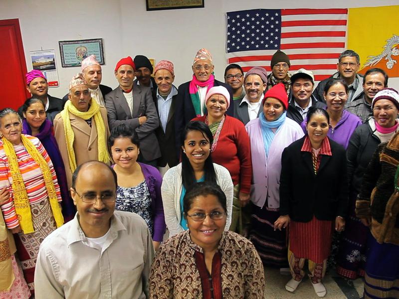 Former refugee Birendra Dhakal poses for a picture with his citizenship class in Clarkston, Georgia.