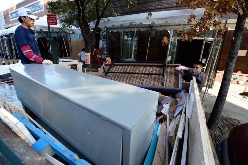 Men remove damaged furniture from a building housing several art galleries November 12, 2012 in the Chelsea section of New York as the city recovers from the effects of Hurricane Sandy.