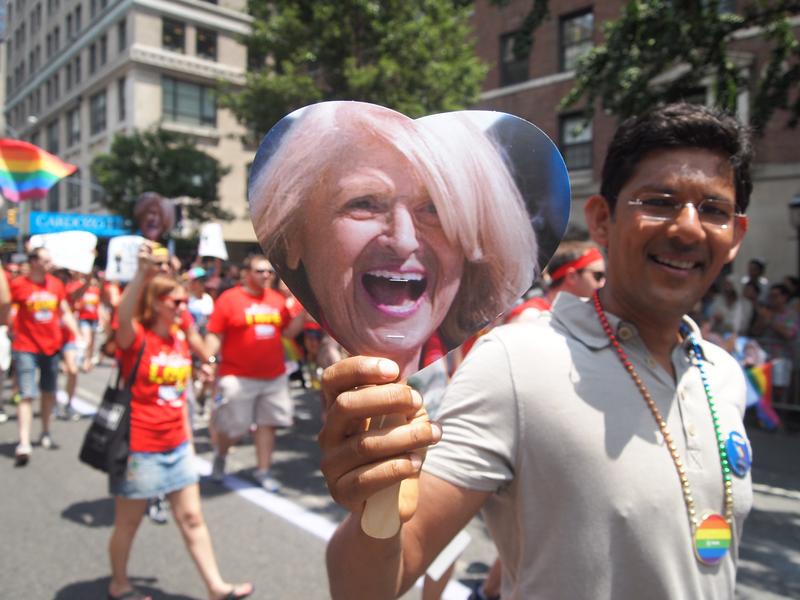 A parade goer holds up the image of Edie Windsor