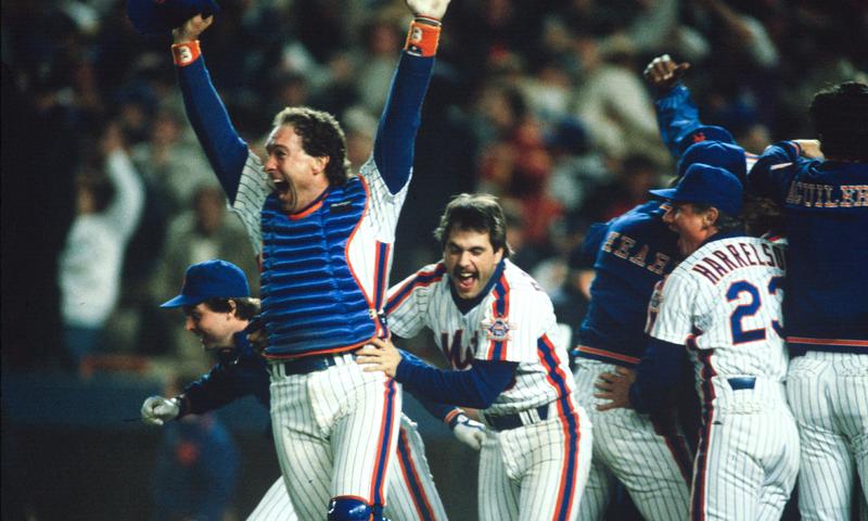 Gary Carter #8 and Wally Backman #6 of New York Mets celebrate after winning the 1986 Major League Baseball World Series