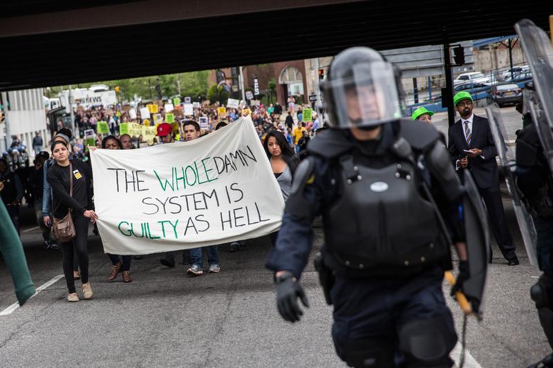 Protesters march through the streets in support of Maryland state attorney Marilyn Mosby's announcement that charges would be filed against Baltimore police officers in the death of Freddie Gray.