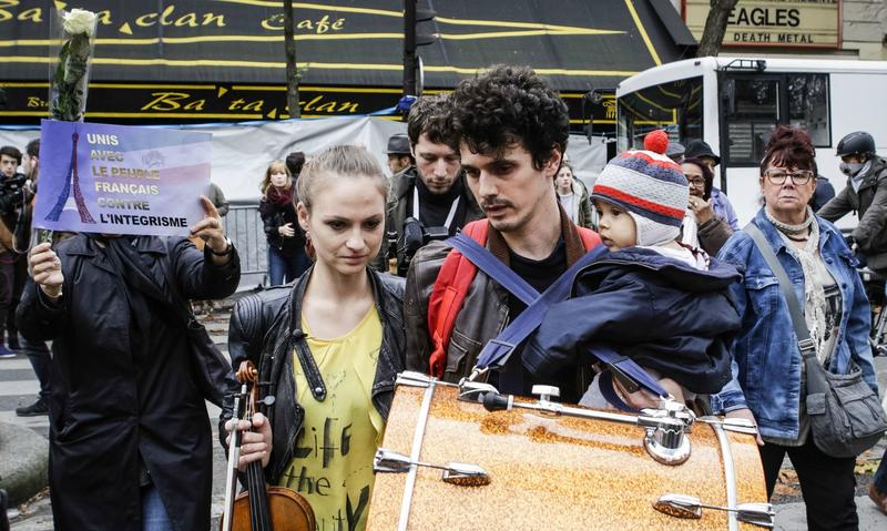 Musicians play a tribute in front of Bataclan, a concert hall and site of last week’s terrorist attacks