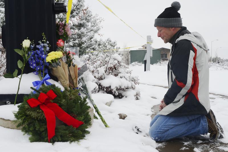 Following the shooting at Planned Parenthood, Roy Kieffer prays after laying flowers at a memorial at Fillmore Street and Centennial Boulevard on November 28, 2015 in Colorado Springs, Colorado.