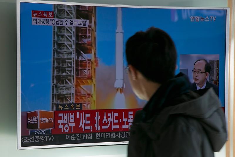 People watch a television screen showing a breaking news on North Korea's long-range rocket launch at Seoul Station on February 7, 2016 in Seoul, South Korea.