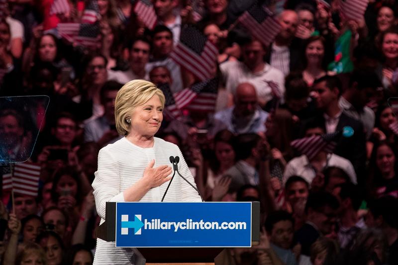 Democratic presidential candidate Hillary Clinton gestures to the crowd at the start of her remarks during a primary night rally at the Duggal Greenhouse in the Brooklyn Navy Yard, June 7, 2016.
