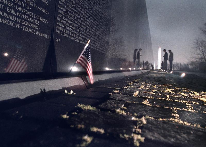 Tourists visit the Vietnam Veterans Memorial in the evening 3/13. People have been complaining that some of the ground lights illuminating the wall were out.