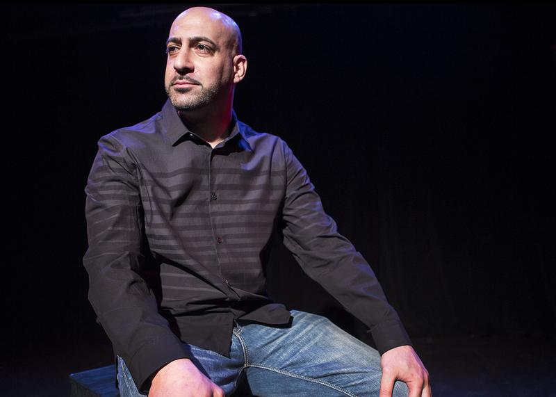 Joe Assadourian in "The Bullpen," a one-man comedy that he wrote about his experiences in prison.