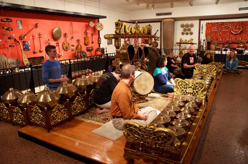 Performers try a selection of instruments from Indonesia on display at the National Music Museum in South Dakota.